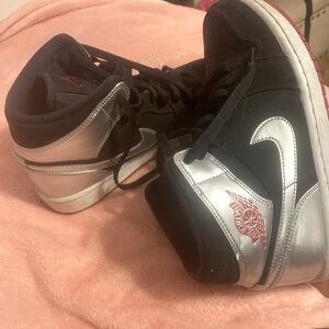black and silver Air Jordan shoes